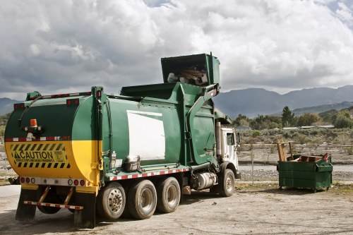 Crew securing load on a waste collection vehicle prior to departure